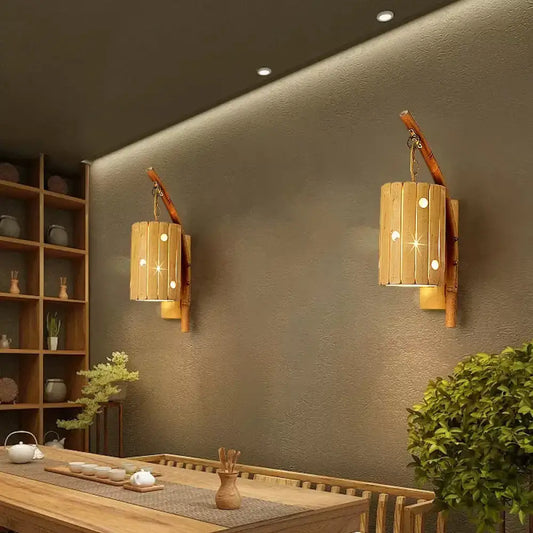 Rustic bamboo cylinder house sconce light fixture with warm glowing lights and natural wood cylinder house design