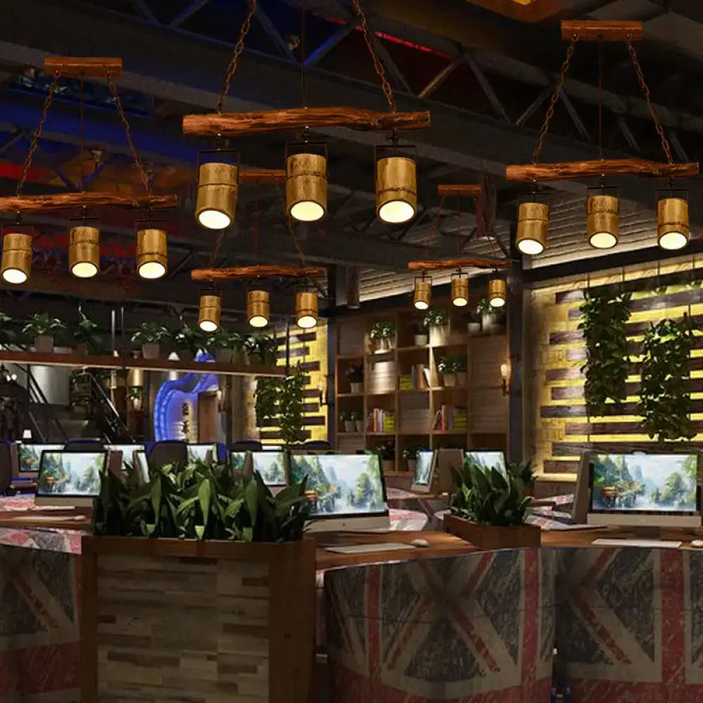 Rustic wooden beam pendant lamp with adjustable cylindrical bamboo shades hanging from chains in bamboo island lighting fixture