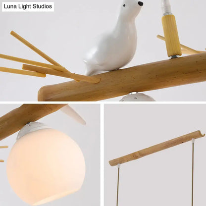 DecorBites modern cream glass wood pendant light fixture with white bird deco perched on bamboo dome island branch