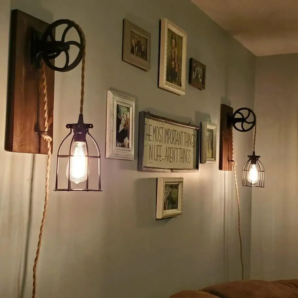 Industrial-style pendant light with dark metal cage bulb holder, rustic wooden plates, and beige hemp woven pendant light cable