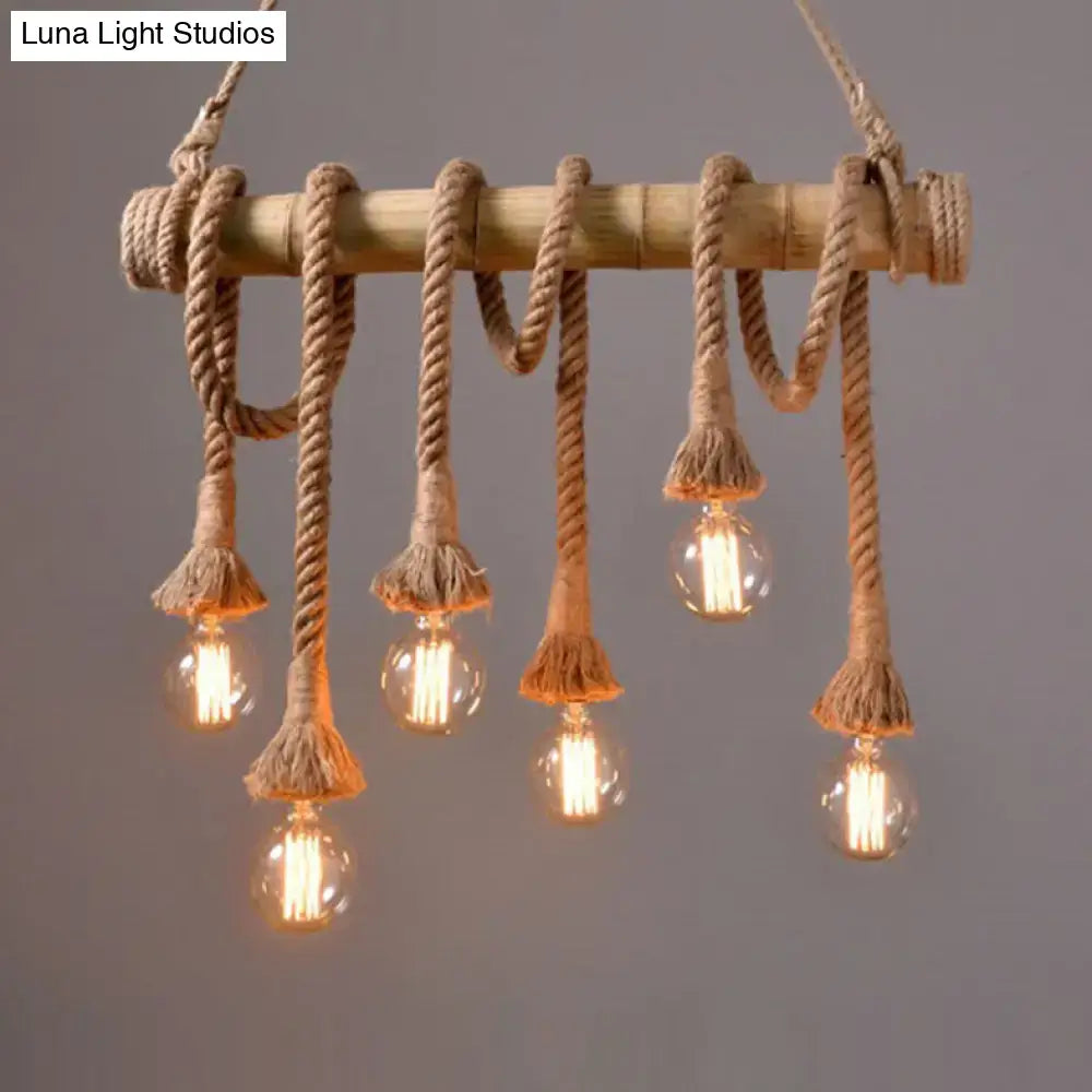 Rustic bamboo pendant with thick beige adjustable rope and frayed tassels holding clear bulbs in rope island light design