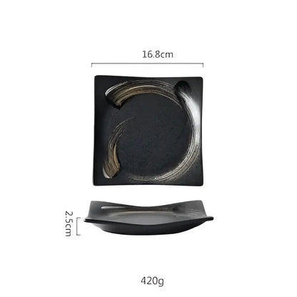 Rustic black ceramic sushi plate with textured surface and curved gold accent from decorbites black ceramic set