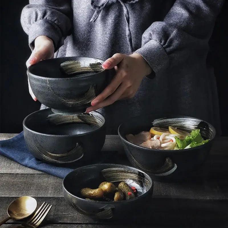 Rustic black ceramic sushi plate and bowl set with gold brushstroke accents and integrated handles for decorbites black ceramic collection