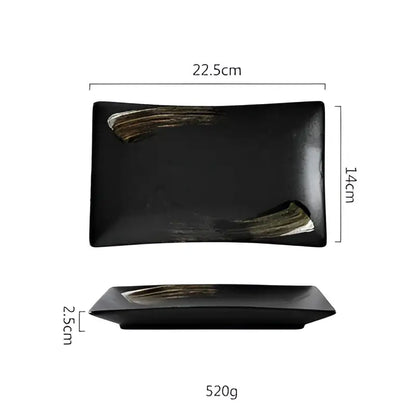 Rustic black ceramic sushi plate with gold brushstroke accents from decorbites black ceramic dining set