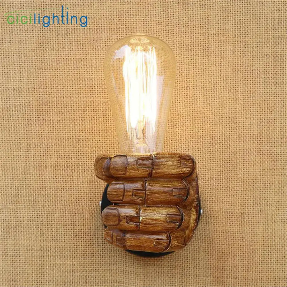 Rustic black and coffee wooden hand wall light pair featuring a glowing amber edison bulb for bedroom decor