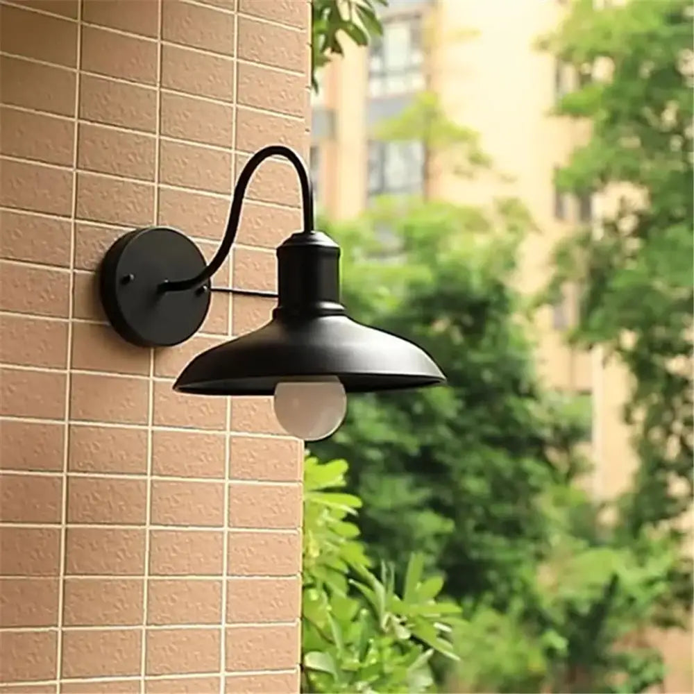 Black rustic gooseneck light fixture with curved arm and dome-shaped shade wall-mounted outdoor sconce by decorbites
