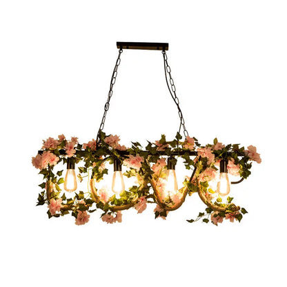 Decorbites black metal 4-light linear island lamp with exposed edison bulbs and hanging pink flowers and green vines