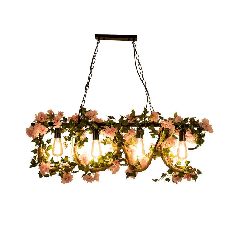 Decorbites black metal 4-light linear island lamp with exposed edison bulbs and hanging pink flowers and green vines