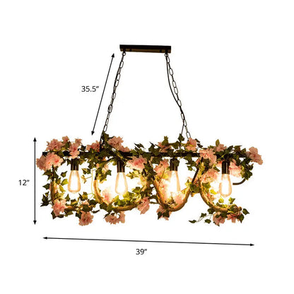 DecorBites black metal linear island lamp with five exposed bulbs and hanging artificial pink flowers and green vines