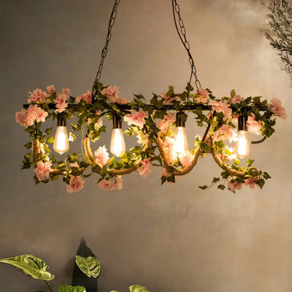 Decorbites black metal 4-light linear island lamp with pink artificial flowers and exposed edison bulbs in lodge style