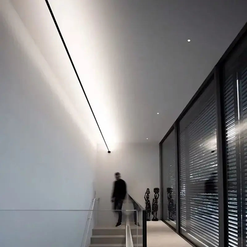 A sleek rustic black and white steel wall lamp strip with bright white illumination for aisle brick decor