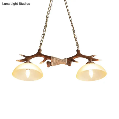 DecorBites brown glass island lamp with antler-themed rustic metal frame and two warm glass shades suspension light