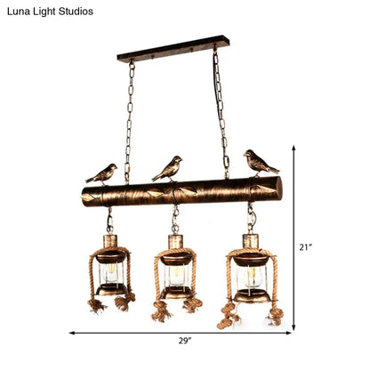 Bronze finished rustic metal caged island pendant light with three lanterns rope detailing and decorative birds by decorbites