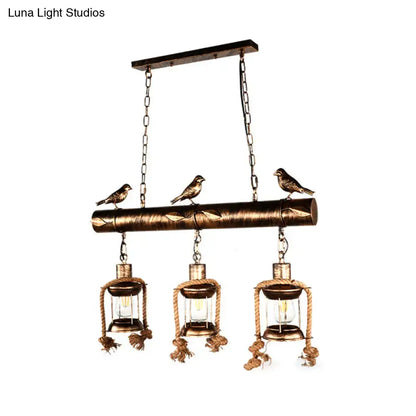 Decorbites™ coastal style metal caged island pendant light in bronze with three lanterns rope detailing and bird figurines