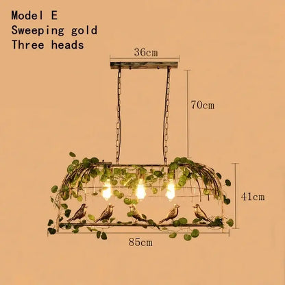 Rustic bronze leaf bird cage chandelier featuring a sweeping gold three-head pendant with ornate bird and vine design