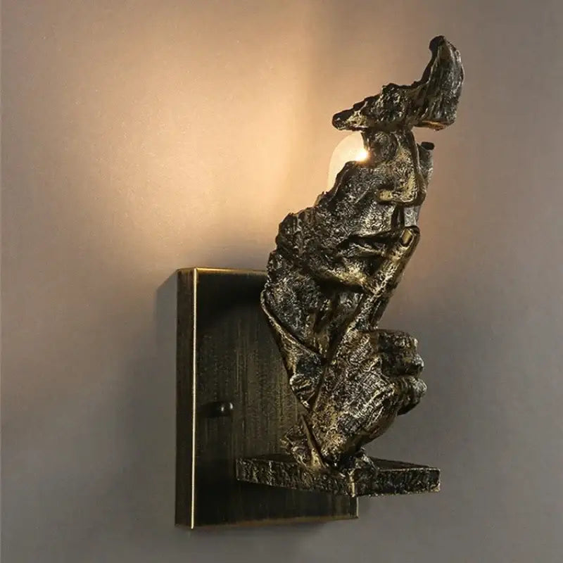 Rustic bronze wall lamp decorbites loft face with abstract textured figure sculpture for living room decor
