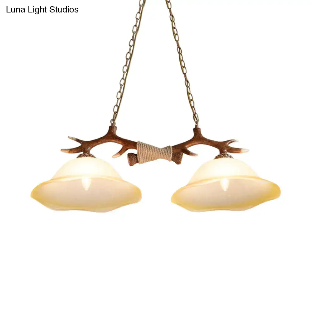 DecorBites 2-light traditional bell glass island pendant with antler design brown metal frame and warm LED incandescent shades