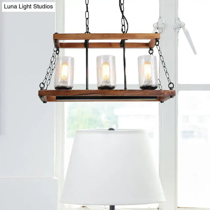 Rustic brown pendant light with wooden trapezoid guard and seeded glass candle holders on black metal chains for living room