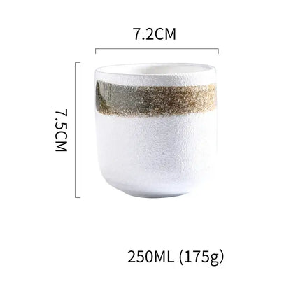 Rustic coarse ceramic tea cup with textured white surface and gold gray speckled band ideal for decorbites coarse ceramic set