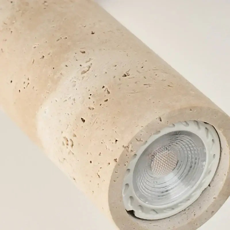 Beige concrete cylindrical led wall sconce with visible bulb and dark wood accents for bedroom decorbites led wall lighting