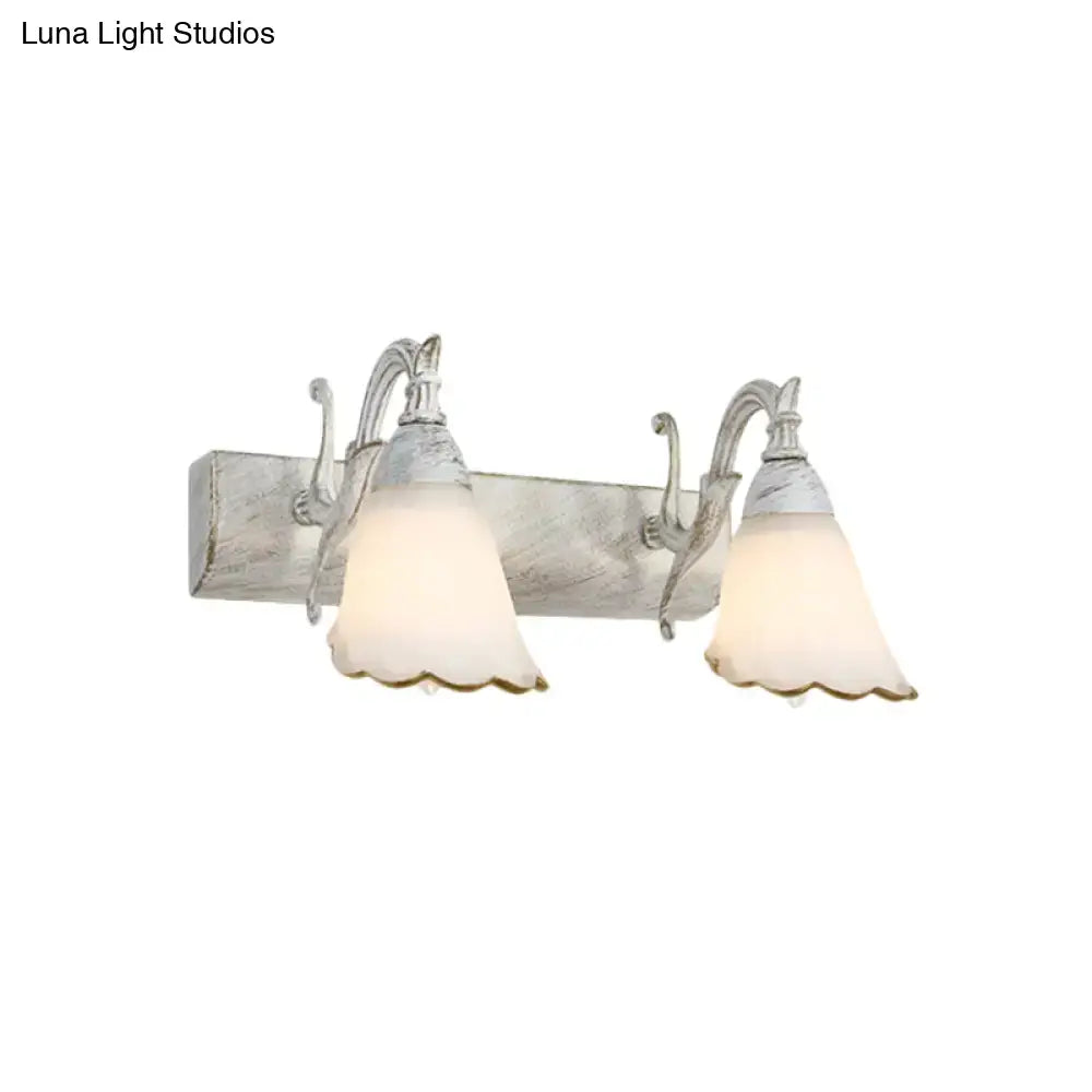 Antique white distressed wood wall light with two metal arms and frosted glass shades for 110v-120v use