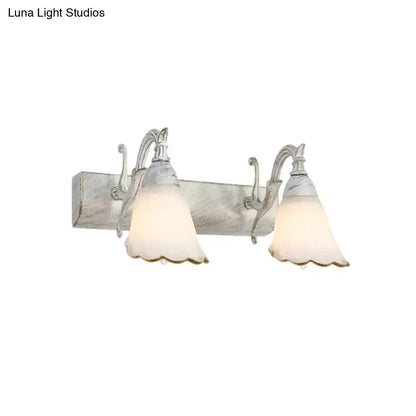 Antique white distressed wood wall light with two metal arms and frosted glass shades for 110v-120v use