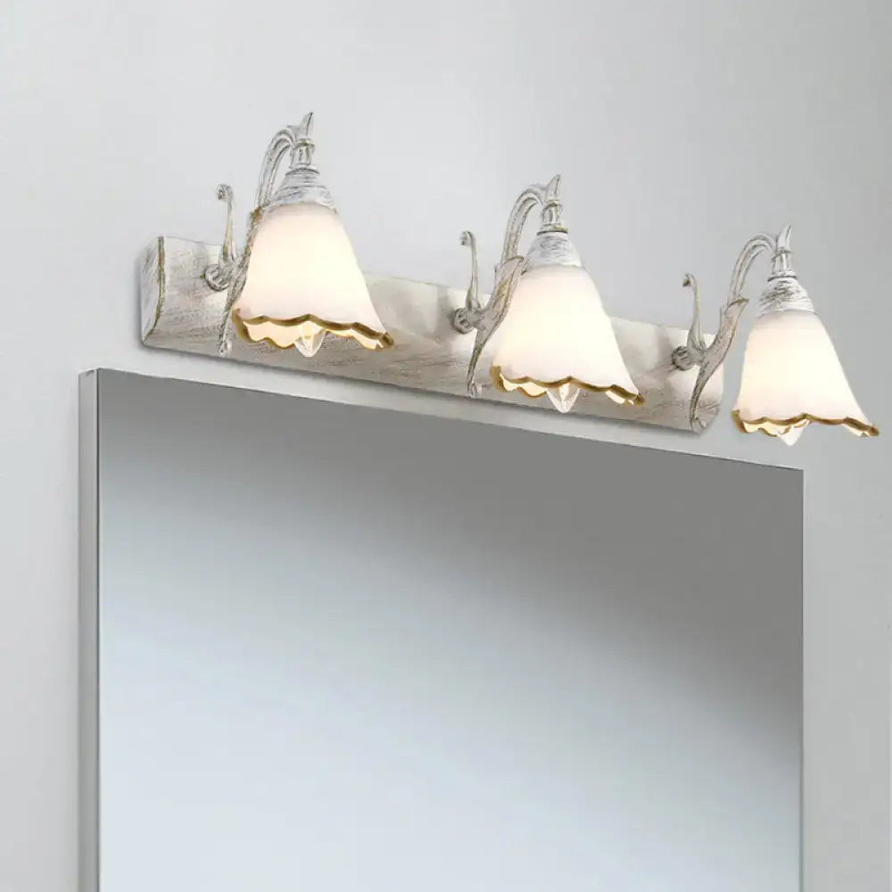 Silver-finished three-light wall light with frosted scalloped glass shades and subtle gold trim for 110v-120v bathroom vanity