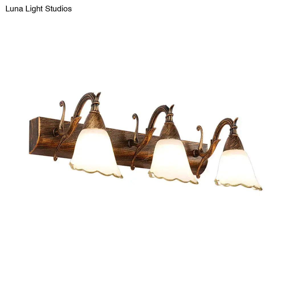 Antique bronze-finished wall light with three frosted glass bell shades and wooden base for 110v-120v bathroom vanity