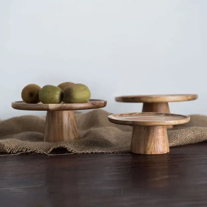 Three rustic decorbites elevated wooden cake stands with natural wood grain and warm light brown finish for serving