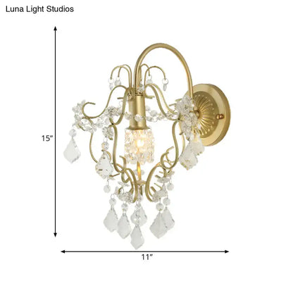 Rustic gold crystal wall mount lamp with ornate metalwork and dangling clear crystal droplets for elegant lighting