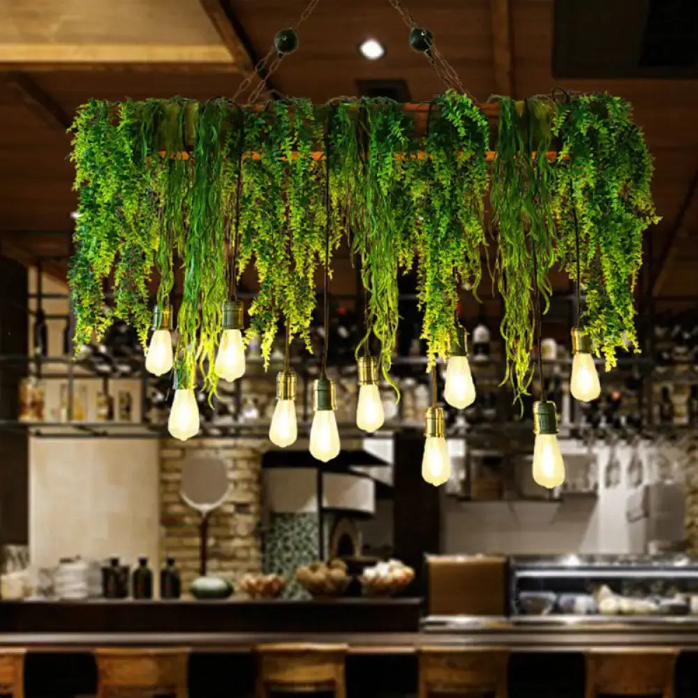 Rustic iron rose pendant light fixture with lush green fern draped chandelier and multiple exposed edison bulbs with chain cord length