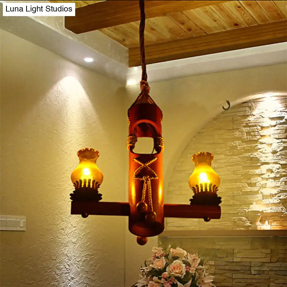 Rustic red metal pendant light with two glowing amber glass lamps and rope detailing kerosene island light retro black yellow