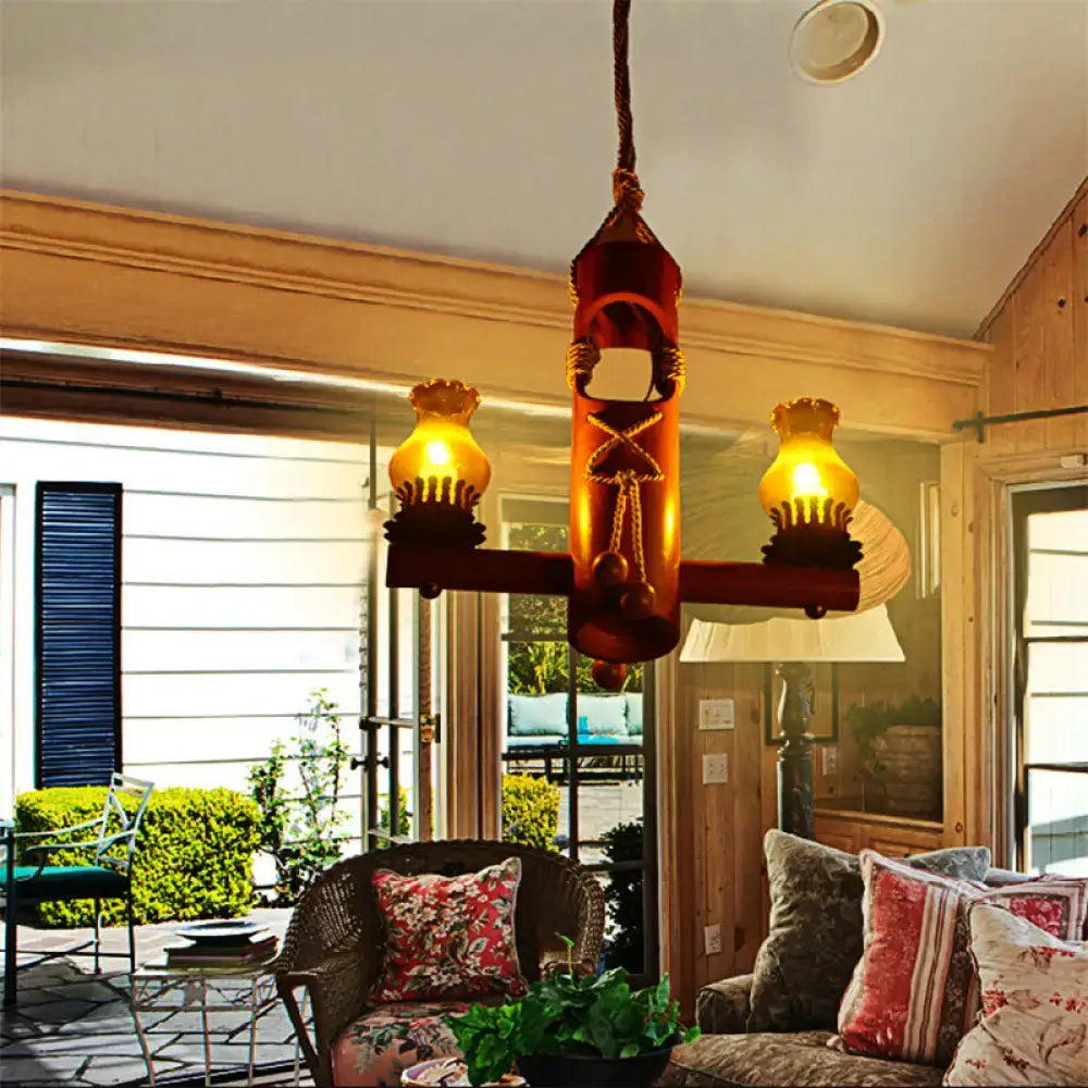 Rustic wooden chandelier pendant light with three amber glass lamps and rope design in retro black yellow kerosene island light style