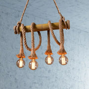 Rustic bamboo island light with thick beige rope and four glowing filament bulbs from decorbites lodge industrial series