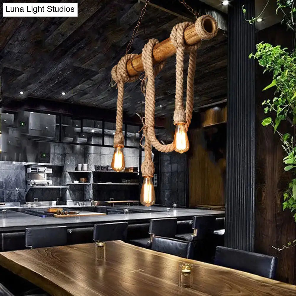 Rustic industrial island light with natural bamboo poles, beige rope suspension, and three exposed edison bulbs by decorbites