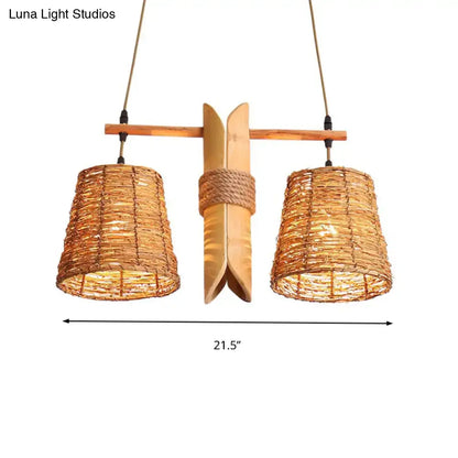 Natural woven rattan pendant light fixture with two warm-toned cone shades, wooden crossbar, and bamboo design