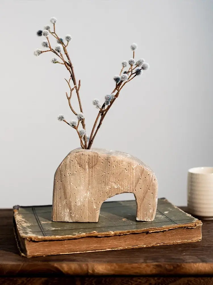 A rustic light beige stone elephant-shaped hydroponic vase with textured surface for decorbites garden rattan use