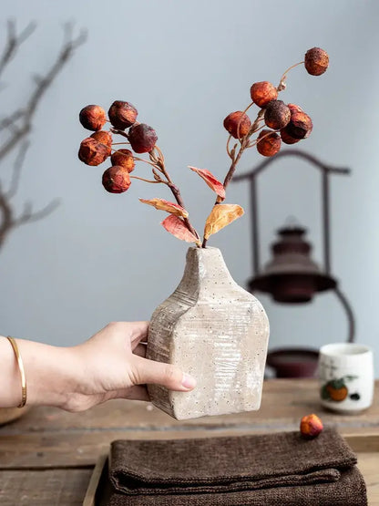 Beige speckled ceramic hydroponic vase with textured handcrafted surface holding dried autumn berries for decorbites garden rattan