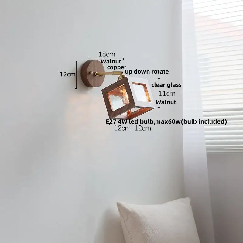 Rustic walnut wood and brass wall sconce with clear glass cube fixture in walnut and copper finish for bedroom use