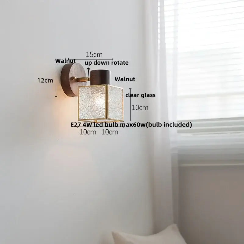 Rustic walnut wood and brass wall sconce with clear textured glass panels and walnut-finished circular backplate