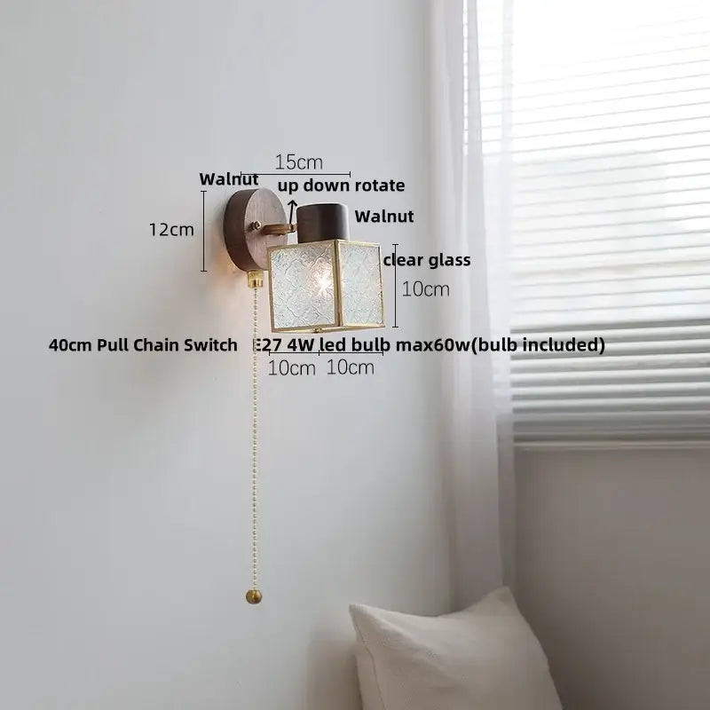Rustic walnut wood and brass wall sconce with clear glass etched panels and square brass frame for bedroom use