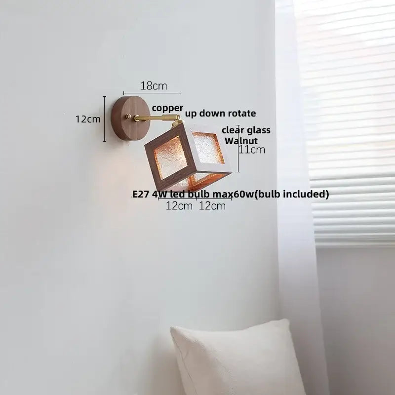 Rustic wall sconce with copper finish, walnut wood base, and clear glass cube fixture for bedroom use