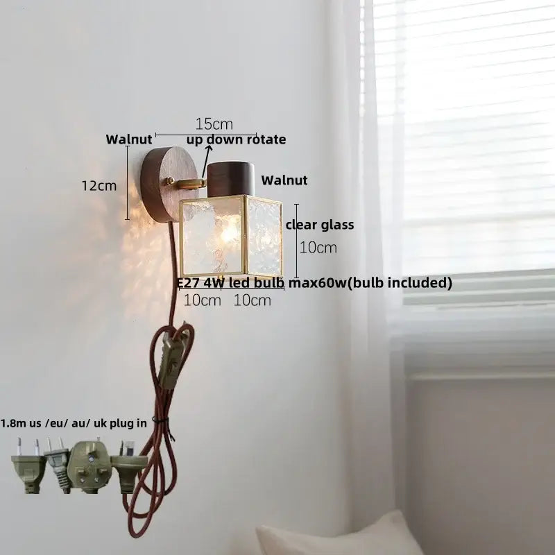 Rustic walnut wood wall sconce with brass accents and clear glass panels mounted on circular walnut backplate