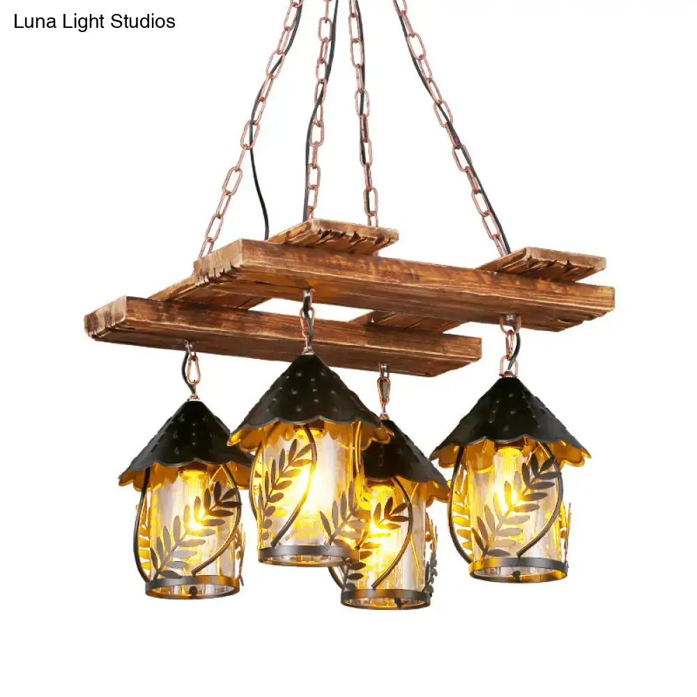 Rustic wooden chandelier with three clear glass lanterns featuring leaf etchings and black metal arm roofs