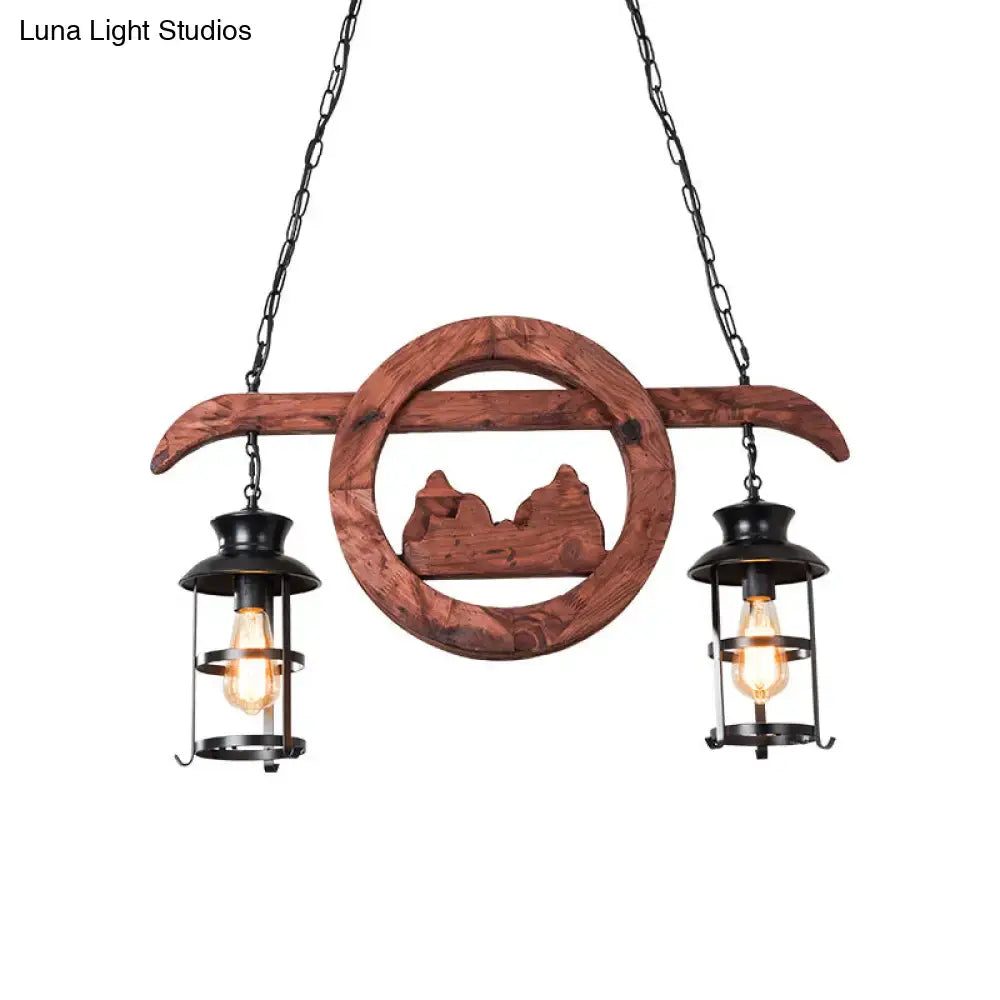 Rustic brown wooden lantern pendant lamp with black metal lanterns and carved mountain silhouette by DecorBites
