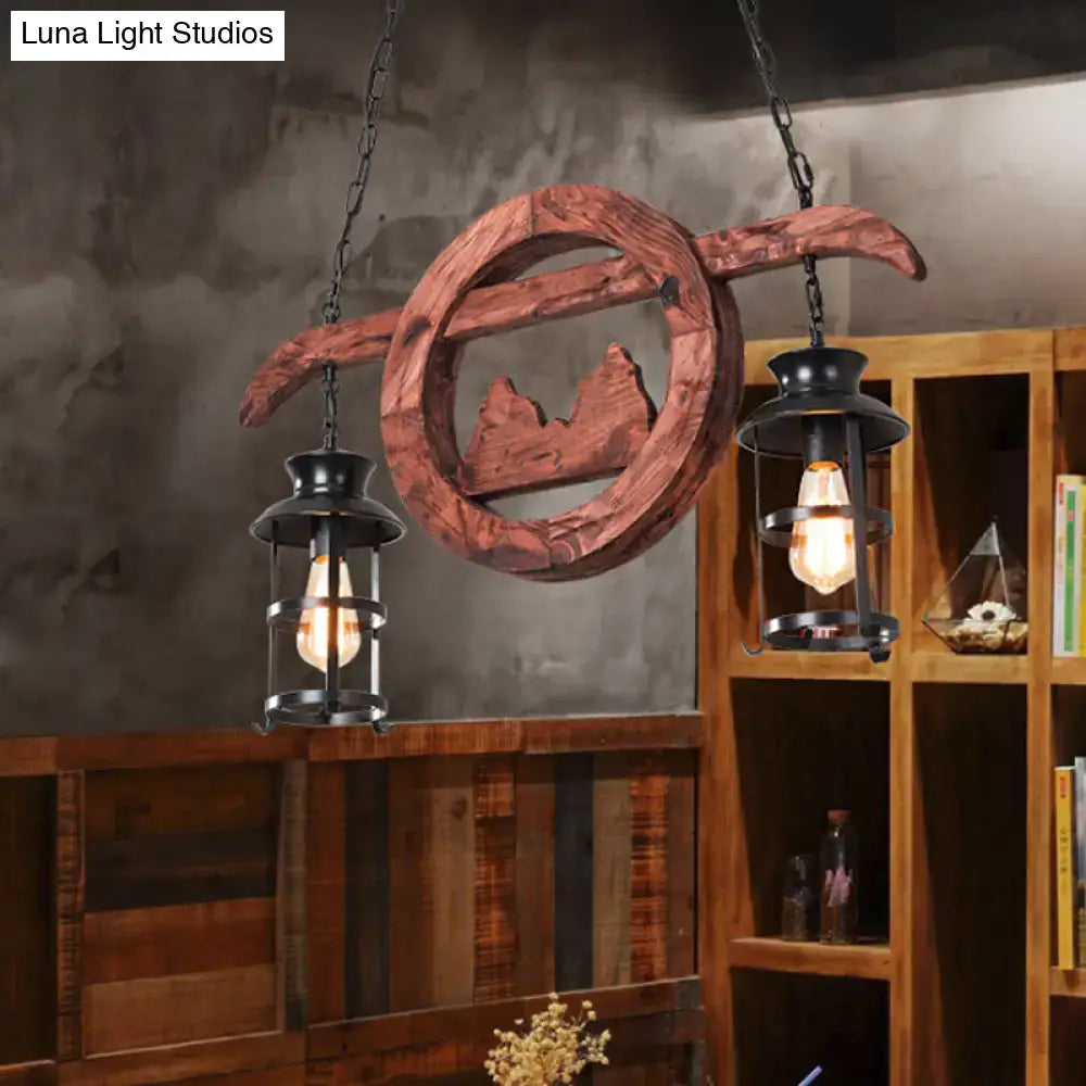 Rustic wooden circular lantern pendant lamp with mountain silhouette and two black lantern pendant fixtures