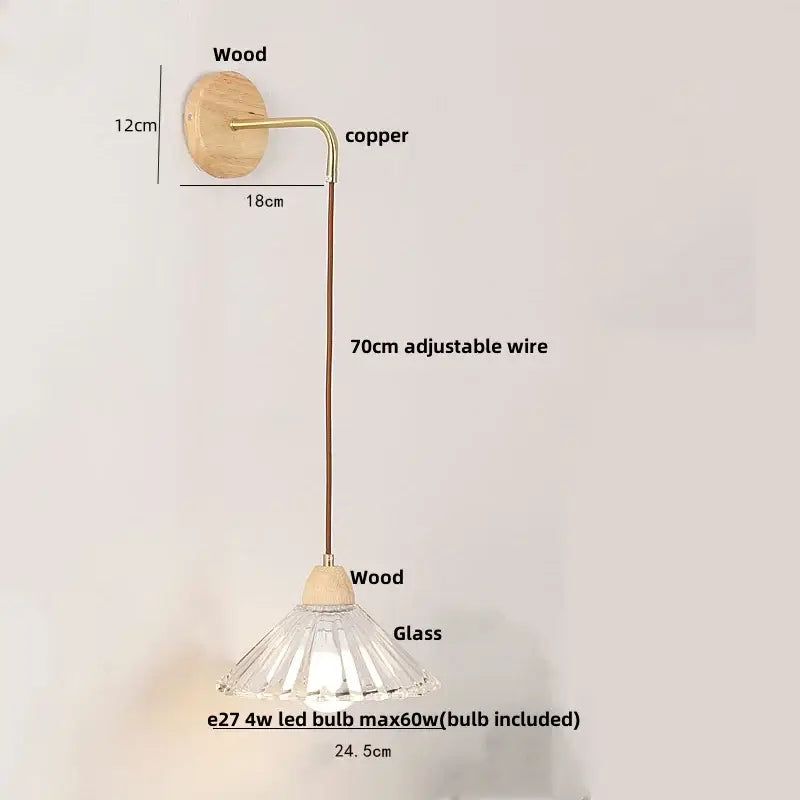 Rustic wood and brass wall light with a clear glass faceted lampshade and pull chain switch with copper wire arm