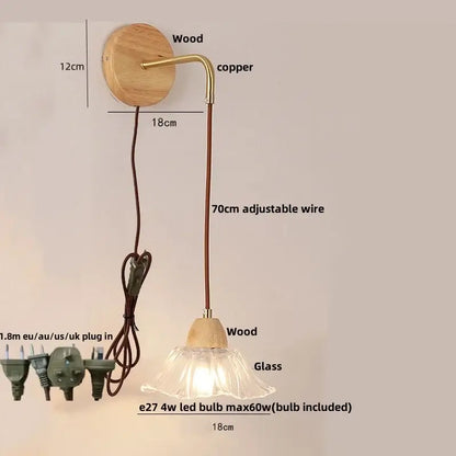 Rustic wood and brass wall light with clear glass bell shade and pull chain switch featuring 70cm adjustable cord
