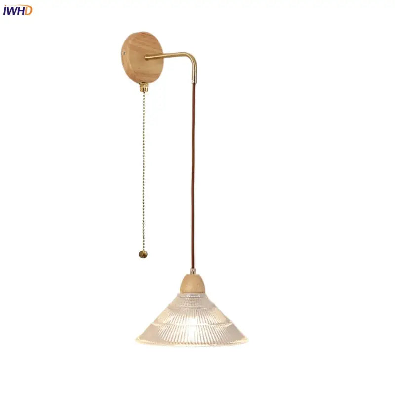 Rustic wall light with wooden base, brass metal arm, clear glass shade, and pull chain switch for easy use