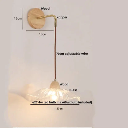 Rustic wood and brass wall light with clear glass flower-shaped lampshade and warm glow featuring a pull chain switch